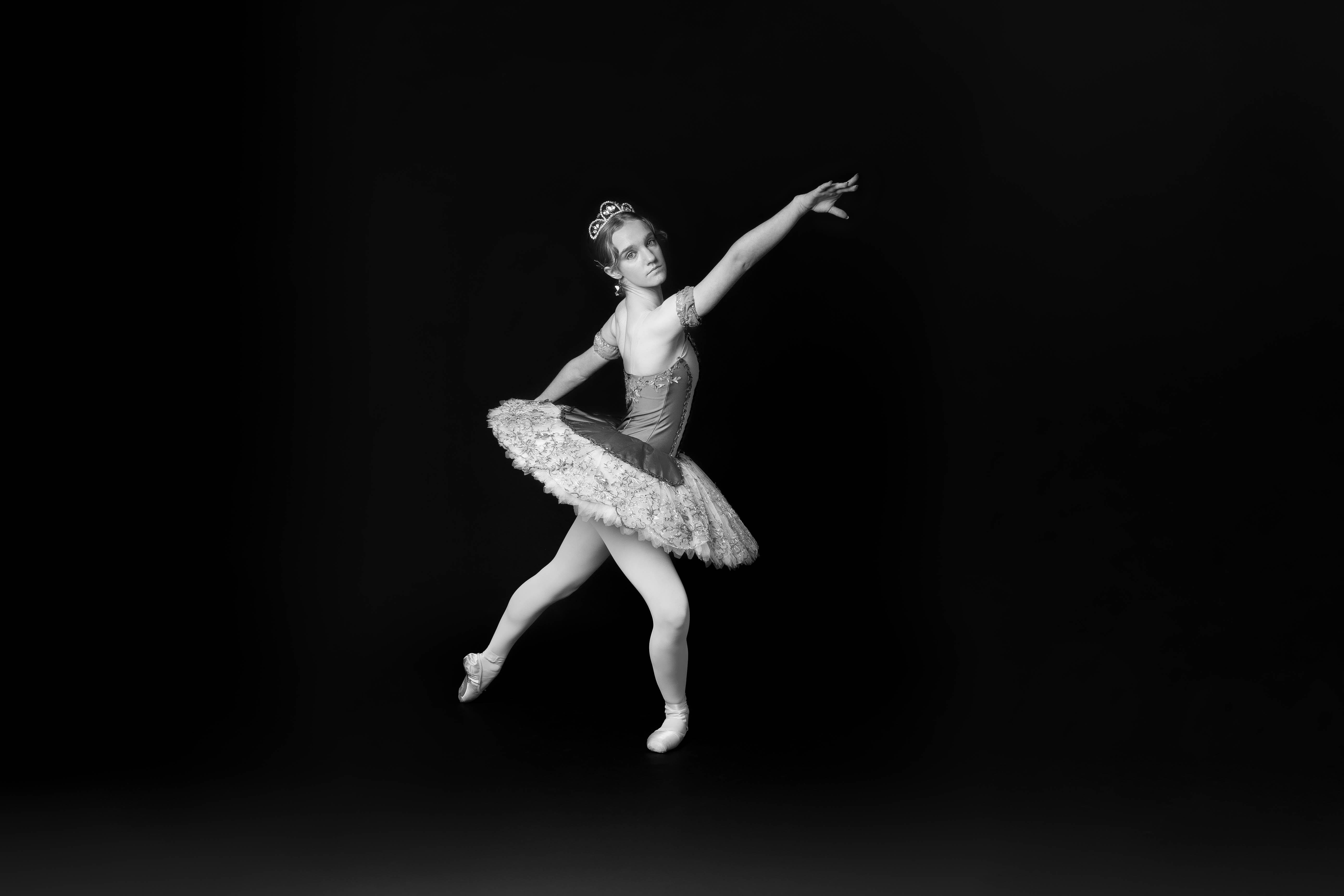 Ballerinas captured mid-performance, showcasing extension and movement